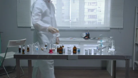 Man in protective workwear and mask work in the laboratory Stock Footage 123679165