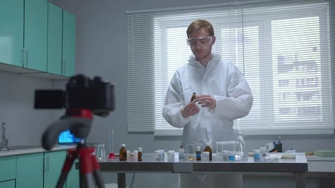 Man in protective workwear show his work on camera in the laboratory Stock Footage 123677421