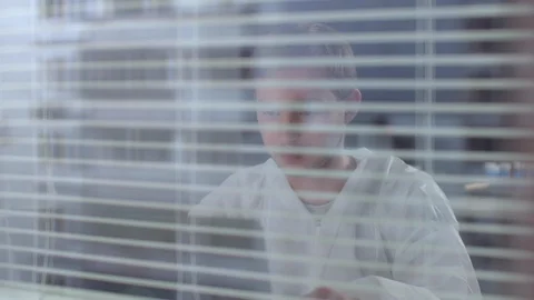 Man in protective workwear sit and work with computer and documents in the Stock Footage 123664569