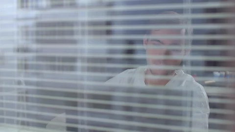 Man in protective workwear wave to someone and talk in the laboratory Stock Footage 123684690