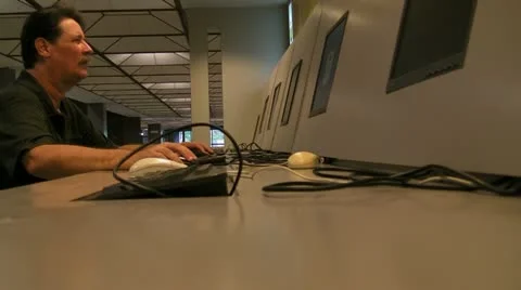 Man at public computer stations 1 Stock Footage 10902550