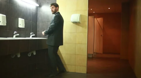 Man in a public restroom Stock Footage 61819365