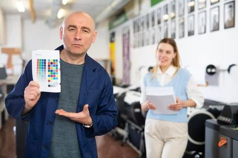 Man publishing facility worker with colour test page Stock Photos