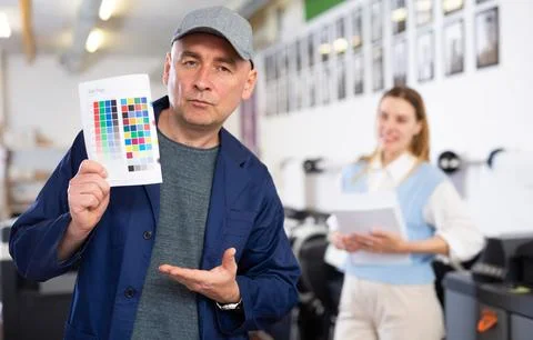 Man publishing facility worker with colour test page Stock Photos