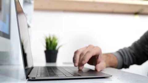 Man puff book on the desk. Computer on the background Stock Footage 98457417