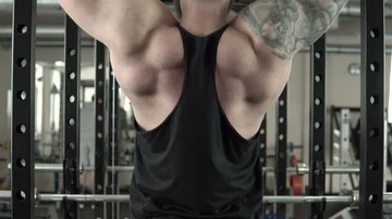 A man pull-ups in the gym close-up 4k. Stock Footage 85592506