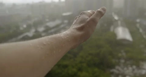 Man Pulled Hand from Balcony. Framed under Torrential Downpour. Rain. Wet Skin Stock Footage 134332987