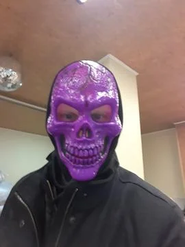 Man pulled out purple skeleton mask Stock Photos