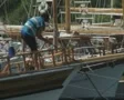 Man pulling up anchor chain at front of gulet SD Footage