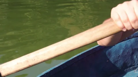 Man pulling a blue boat with oar, faceless Vidéo 67560736