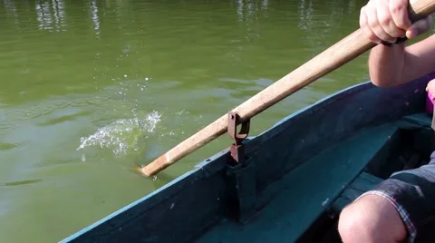 Man pulling a blue boat with oar, faceless 動画素材 67560762