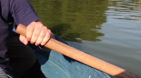 Man pulling a blue boat with oar, faceless Vidéo 67560765