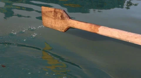 Man pulling a blue boat with oar, faceless Vidéo 67560892