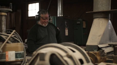 Man pulling board out of woodworking machine Stock Footage 102045002