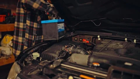 Man Pulling Car Battery Inside Home Garage Stock Footage 340015480