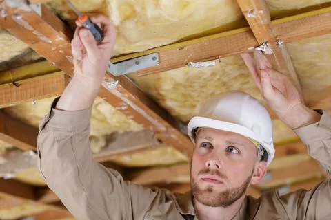 Man pulling to the ceiling in repair loft apartment Stock Photos