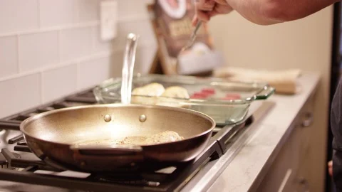 Man pulling chicken out of a pan Stock Footage 113474147