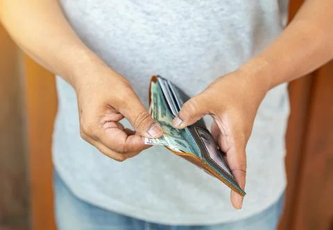 The man pulling dollar banknote to pay product. Stock Photos