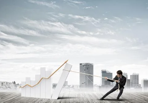 Man pulling with effort big pulling rope graph, as a symbol of financial growth Stock Photos