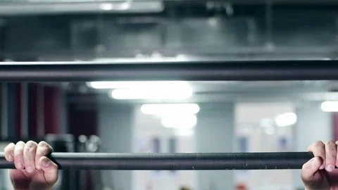 Man pulling up in a gym Stockbeeldmateriaal 75158724