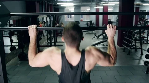 Man pulling up in a gym Stock Footage 75159415
