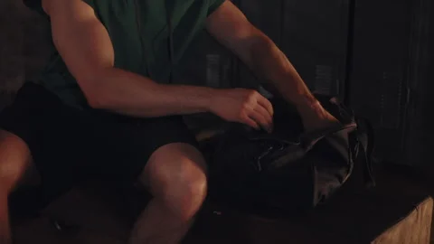 Man pulling hand wraps from gym bag before training 스톡 동영상 332836269