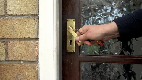 Man pulling a home door closed then locking it. Stock-Footage 89834342