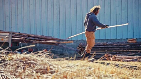 Man Pulling Long Wooden Plank From Lumber Stack Stock Footage 346569262
