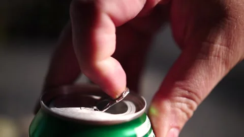 Man pulling the metal tab on a green beverage can Stock Footage 151501992