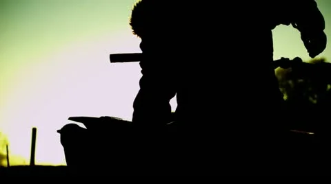 Man pulling motocross bike off pick-up truck Stock Footage 22196341