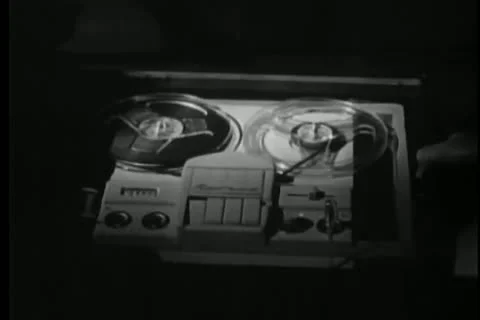 Man pulling out drawer and switching on tape recorder Stock Footage 25195483