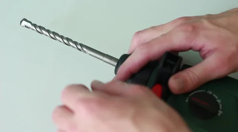 Man pulling out a drill from the perforator Stock Footage 65370999