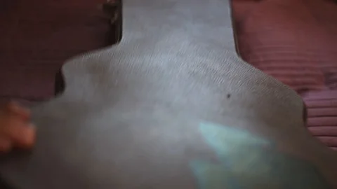 Man pulling out a guitar out of case. Musician is preparing for performance Stock Footage 104395700