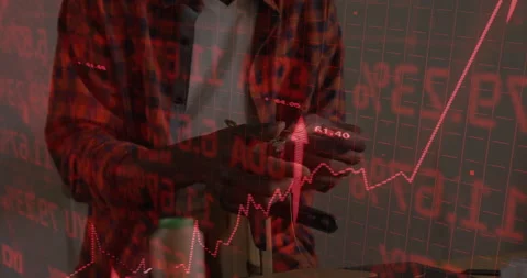 Man pulling phone from pocket tapping screen as red stock chart arrow surging Stock Footage 312005875