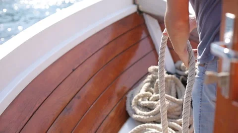 Man pulling rope to moor a ship Stock Footage 66199366