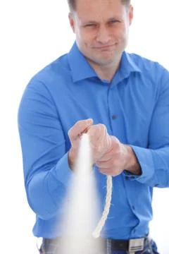 Man pulling on a rope Stock Photos