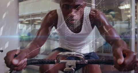 Man pulling rowing handle, starting stroke in gym, camera moving closer, charts Stock Footage 331333571