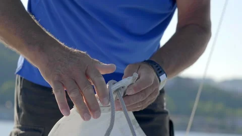 Man pulling sailboat lines on sail in trieste gulf 스톡 동영상 233673325