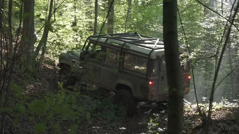 Man pulling a string tied to a car at an offroad event Stock Footage 100861698