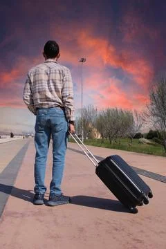 A man is pulling a suitcase with a handle. Holiday Conspet. Summer Time Stock-Fotos