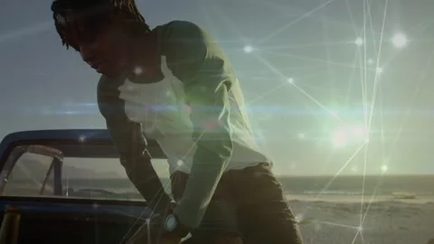 Man pulling truck to coast checking hood sitting watching sunset network overlay Stock Footage 333575044