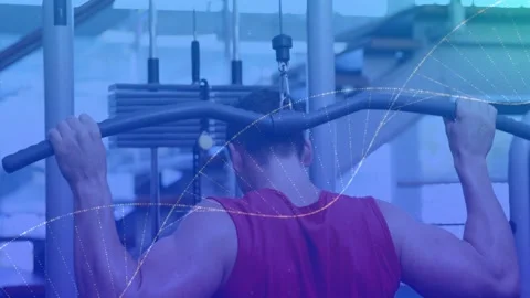 Man pulling wide lat pulldown bar, wearing red sleeveless shirt at gym station Stock Footage 330621224