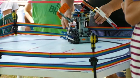 Man pulls apart colliding robots in the ring Stock Footage 123581309