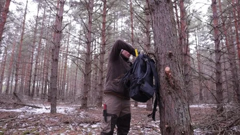 Man pulls axe from backpack, bushcraft Stock Footage 201109979