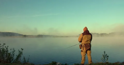 The man pulls the bait out of the water Stock Footage 154941913