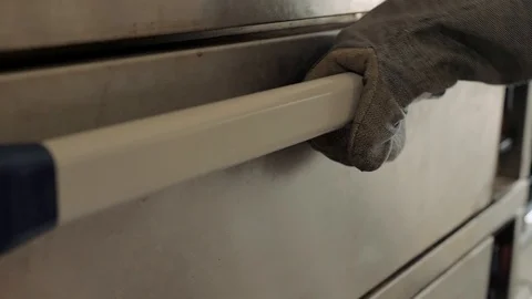 Man pulls bread out of the oven Stock Footage 111421182