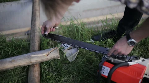 Man pulls a chain on a chainsaw Stock Footage 59365805
