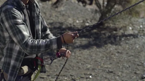 Man Pulls On Climbing Rope, Belaying His Climbing Partner Stock Footage 70473404