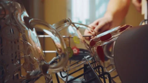 Man pulls dishes out of the dishwasher Stock Footage 144538667