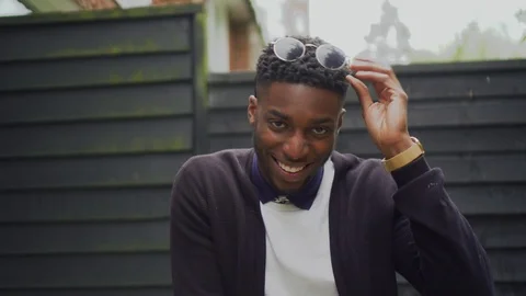 Man pulls down his sunglasses smiling  Stock Footage 89922458
